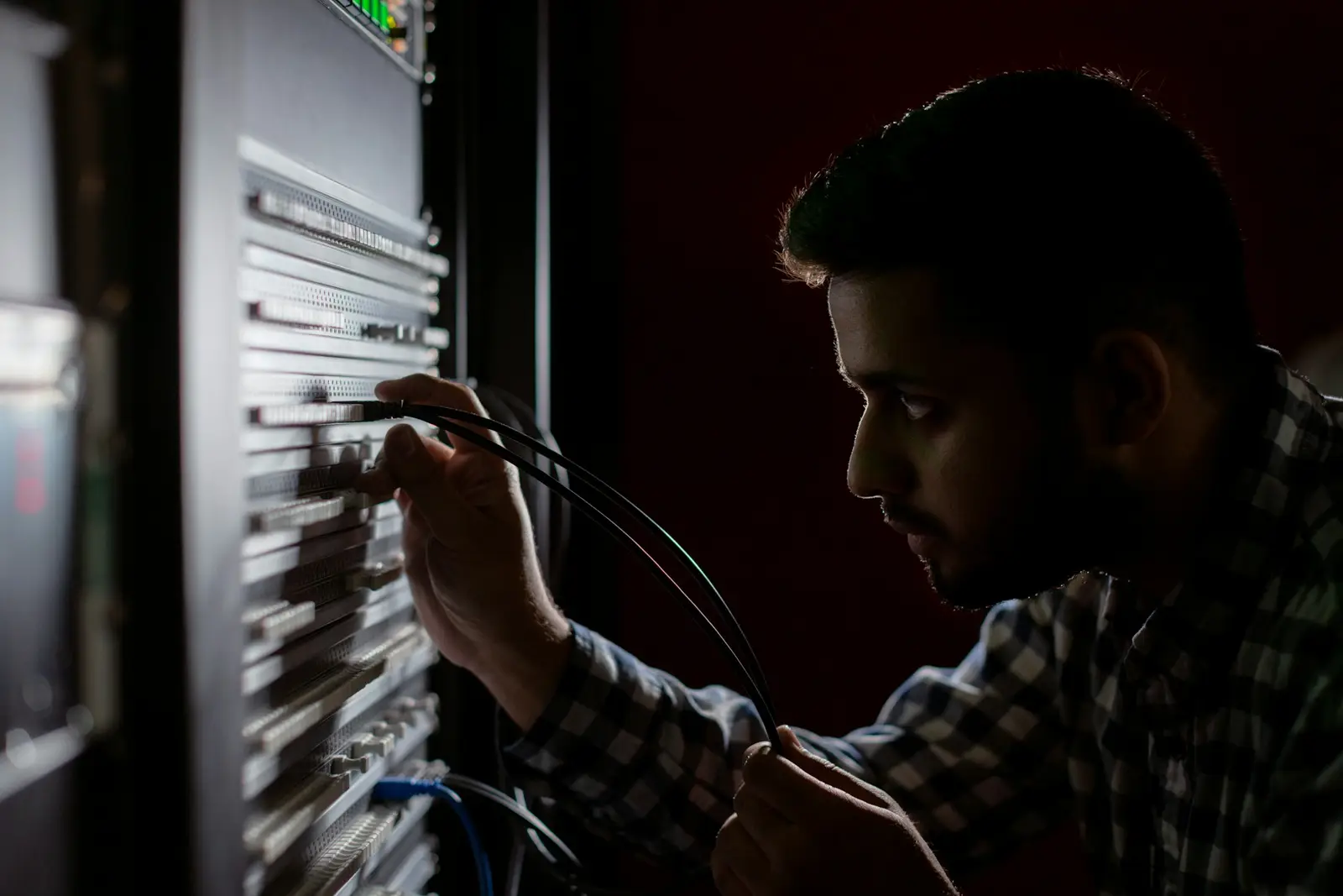 Network engineer working on a server rack